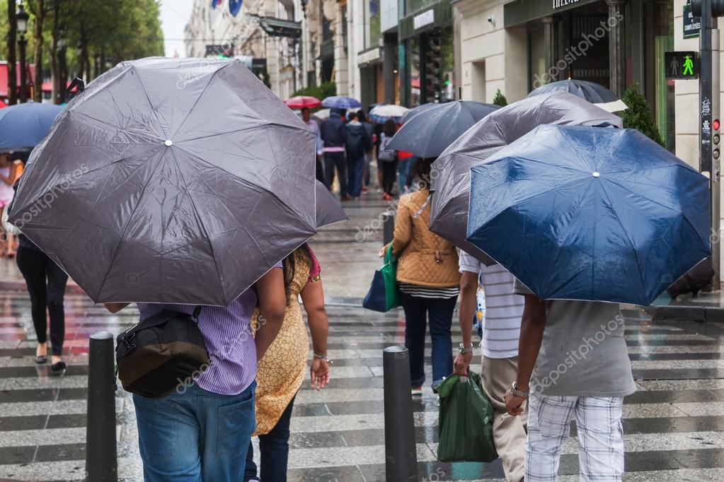 depositphotos_56072609-stock-photo-people-with-rain-umbrellas-crossing